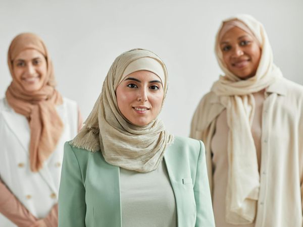 Diverse group of people smiling in a bright, welcoming studio.